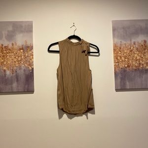 Brown Shirt with ruffled neck like, bow tie on right shoulder.